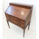 An early 20th century figured mahogany fronted writing bureau; the fall opening to reveal a fitted