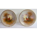 A pair of Crown Devon ceramic plates hand-decorated in the 'Game' pattern. One decorated with a cock