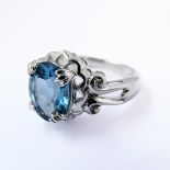 A 9 carat white gold ring set with a central blue stone (possibly aquamarine), ring size M