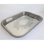 A rectangular silver-plated serving tray with raised gadrooned pierced border and foliate