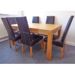 A modern oak dining table on square legs, together with a set of six black leather upholstered