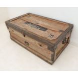 An early 20th century metal-bound two-handled travelling trunk: original paper stick-on labels and