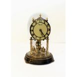 An anniversary clock under a glass dome by 'Hermle' (19cm high including glass dome)