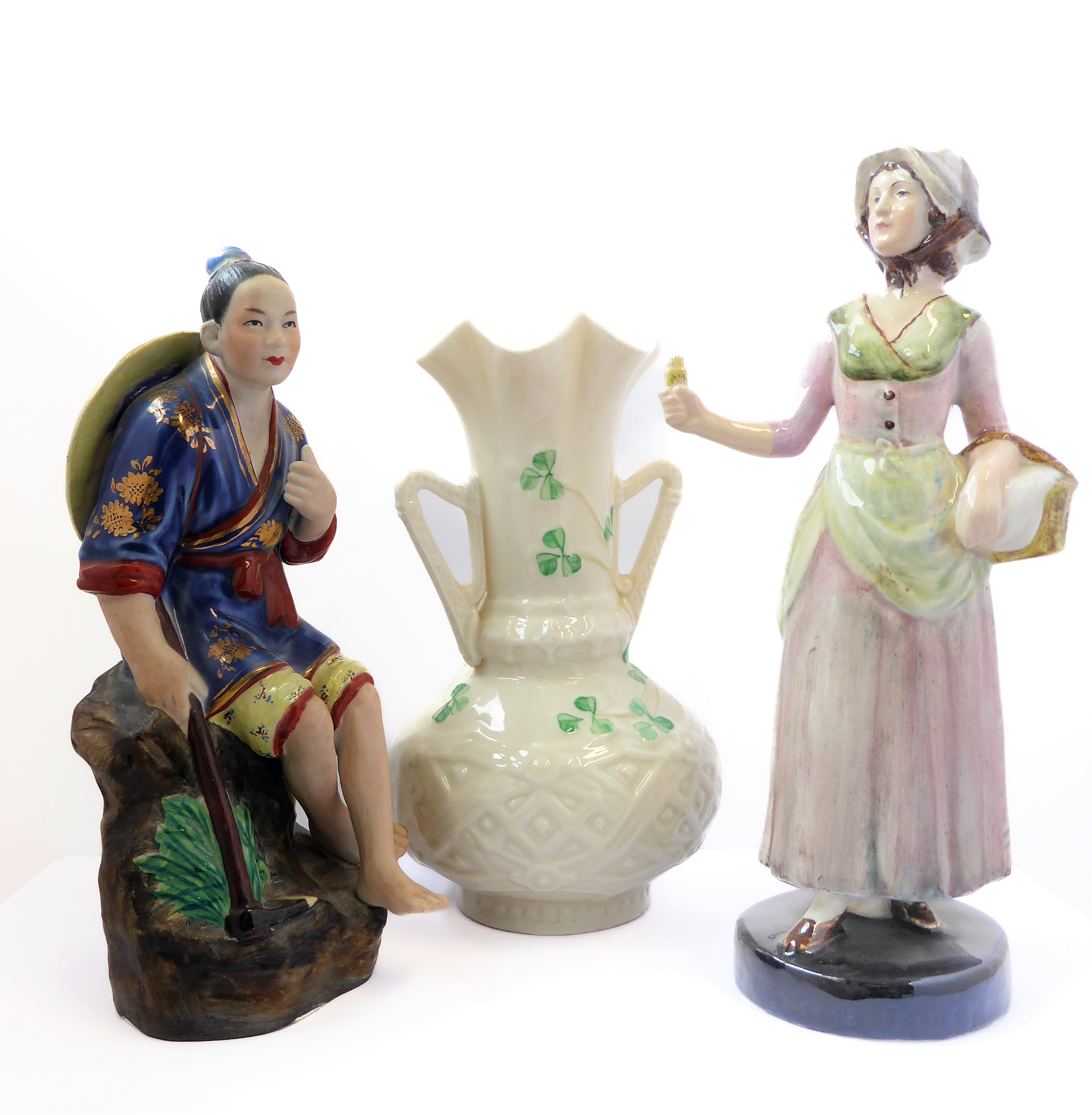 A Belleek twin-handled porcelain vase, a Goldsheider figure and a Japanese figure (3)