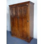 A good reproduction oak two-door wardrobe of slim proportions and good colour: the doors with