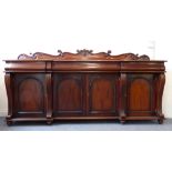 A large 19th century style (modern reproduction) pedestal sideboard; the galleried back carved