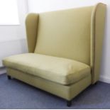 1  A large and modern light green upholstered (with red piping) settle raised on square ebonised