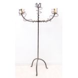 A three-light free-standing wrought metal candelabra (136cm high x 75cm wide)