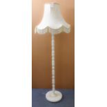 A white onyx lamp-standard on circular base. (137 cm high including electrical fitting.)