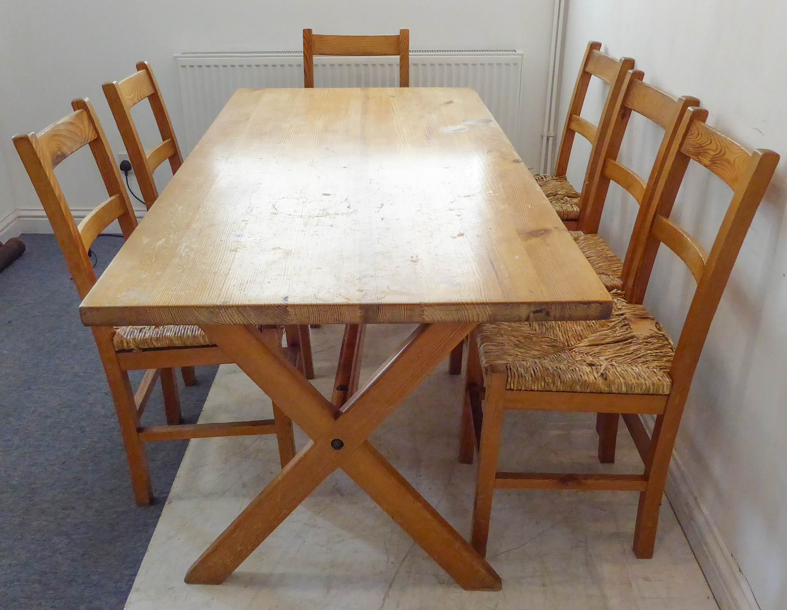 A pine kitchen-style planked top table upon cross form trestle style ends together with seven pine - Image 3 of 3