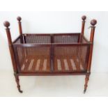 An early 19th century mahogany military campaign-style cot, raised on turned tapering brass