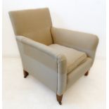 An Edwardian cream upholstered club-style armchair with short square tapering front legs with