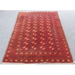 An old Afghan rug: red ground and small guls, circa mid 20th century (condition reasonable) (210cm