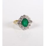 An 18-carat gold, emerald and diamond cluster ring.Ring size O. Setting in good condition overall,