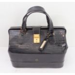 A black crocodile leather vanity case by Asprey of London: gold toned fittings, two top handles, the