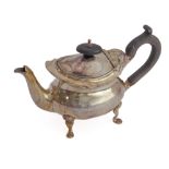 A small silver teapot with oval ebonised knop finial and carved ebonised scrolling handle: the