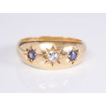 An antique 18ct yellow gold, sapphire and diamond three stone gypsy set ring: hallmarked