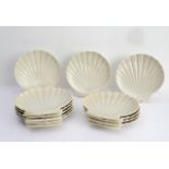 A set of twelve Belleek (County Fermanagh) cream-glazed seafood dishes in the form of scallop