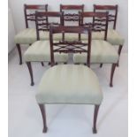 A set of six Regency period mahogany dining chairs: each with strung concave top rail above a finely