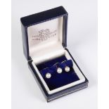 A cased set of three cultured pearl and yellow gold dress studs by Deakin and Francis, the