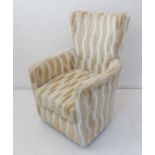 A modern upholstered armchair: unusual beige vertical ovals in low relief (75cm widest x 76cm