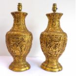 A pair of early 20th century gilded plaster table-lamps decorated in relief in the Chinoiserie style