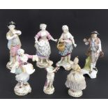 A group of seven porcelain figures: 1. a late 19th century Sitzendorf pair: a lady with a woven