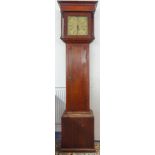 An early 19th century oak-cased longcase clock: outset cornice above an 11-inch brass dial flanked