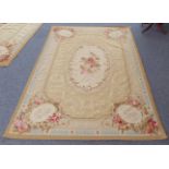 A fine and large French Aubusson tapestry: central cream oval with a spray of roses surrounded by