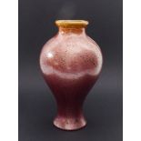 An early 20th century Arts & Crafts baluster-shaped pottery vase: metallic pink lustre-style glaze