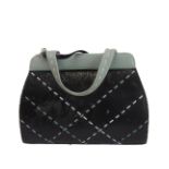 A hand-stitched Radley leather handbag: light-green handles and top, white criss-cross black-leather
