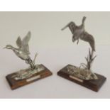 Two small pewter models of mallard ducks in flight: each upon shaped wooden plinth (each plinth 10cm