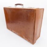 A stitched brown-leather travelling case with fitted upholstered striped interior (61 cm wide)