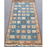 A modern Turkish melas rug: blue field with stylised flowerheads, terracotta border with similar (