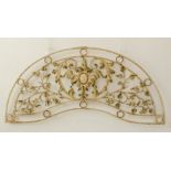 A decorative cast and wrought iron garden arch: central scrolling acanthus leaves surrounding a