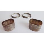 A pair of early 20th century hallmarked silver napkin rings (monogrammed) and a pair of white-