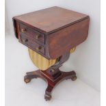 A late Regency or early Victorian rosewood worktable: the two drop-leaves flanking two true and