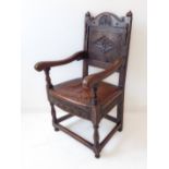 An oak panel-back chair in 17th century style (probably early 20th century): the shaped top rail