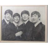 An original framed and glazed black and white poster of The Beatles with facsimile signatures (frame