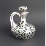 A late 19th century green glass and silver overlay claret jug of onion form: large vacant