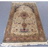 A Kashmir rug: prayer design, with mahrib and two top cobalt blue spandrels with stylised birds