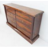 An early 19th century rosewood collector's cabinet: the top with chamfered front and ends, eight