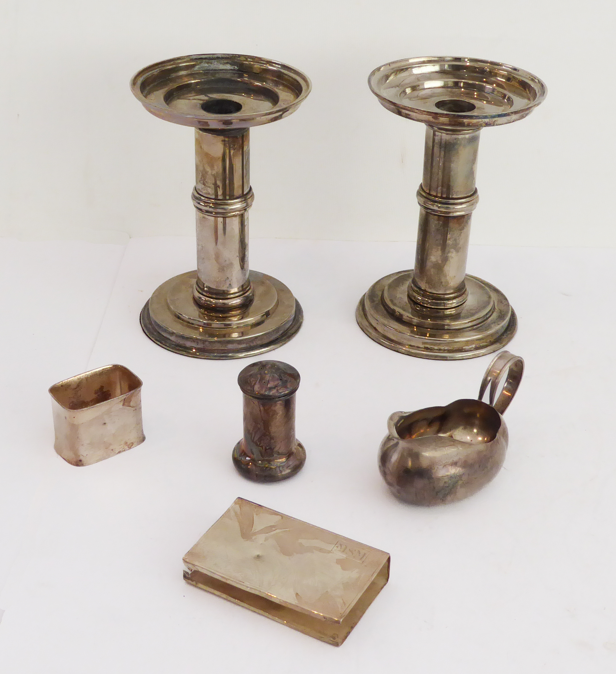 A mixed lot of six: a pair of Arts & Crafts style silver-plated circular table candlesticks (