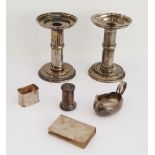 A mixed lot of six: a pair of Arts & Crafts style silver-plated circular table candlesticks (