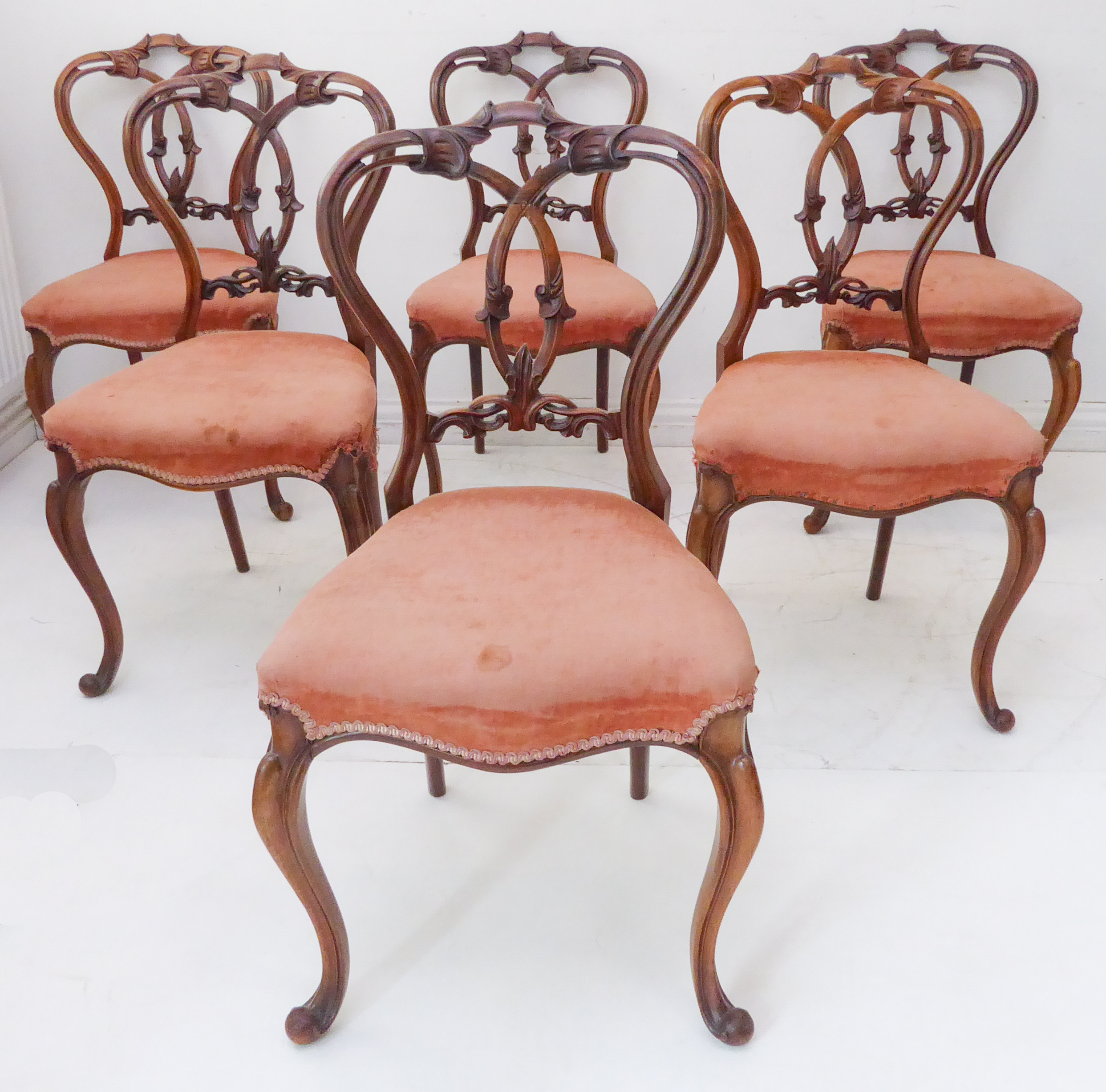 A fine set of six mid-19th century walnut balloon-back salon chairs: ornately carved intertwined