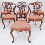 A fine set of six mid-19th century walnut balloon-back salon chairs: ornately carved intertwined