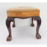A 19th century mahogany stool in mid-18th century style: later overstuffed seat above gadrooning;
