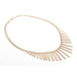 A 1960s 9-carat yellow gold graduated tubular fringe necklace, to the brick link back chain and
