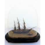 A small scratch-built model of a clipper with steamship alongside, under a glass dome. (The dome and