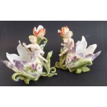 An opposing pair of late 19th century continental porcelain vases modelled as cherubic-style figures